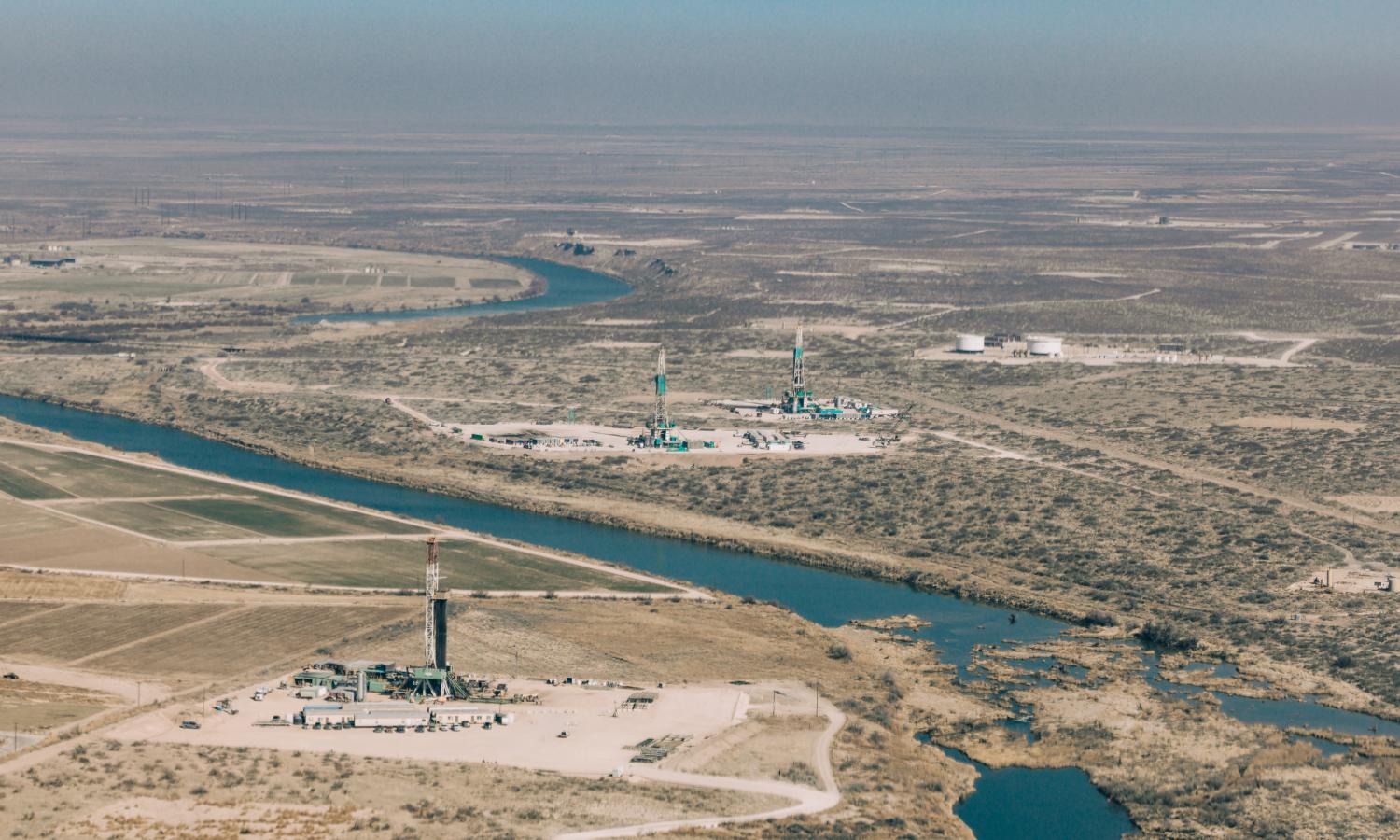 3 drilling rigs alongside the Pecos River outside of Carlsbad, NM