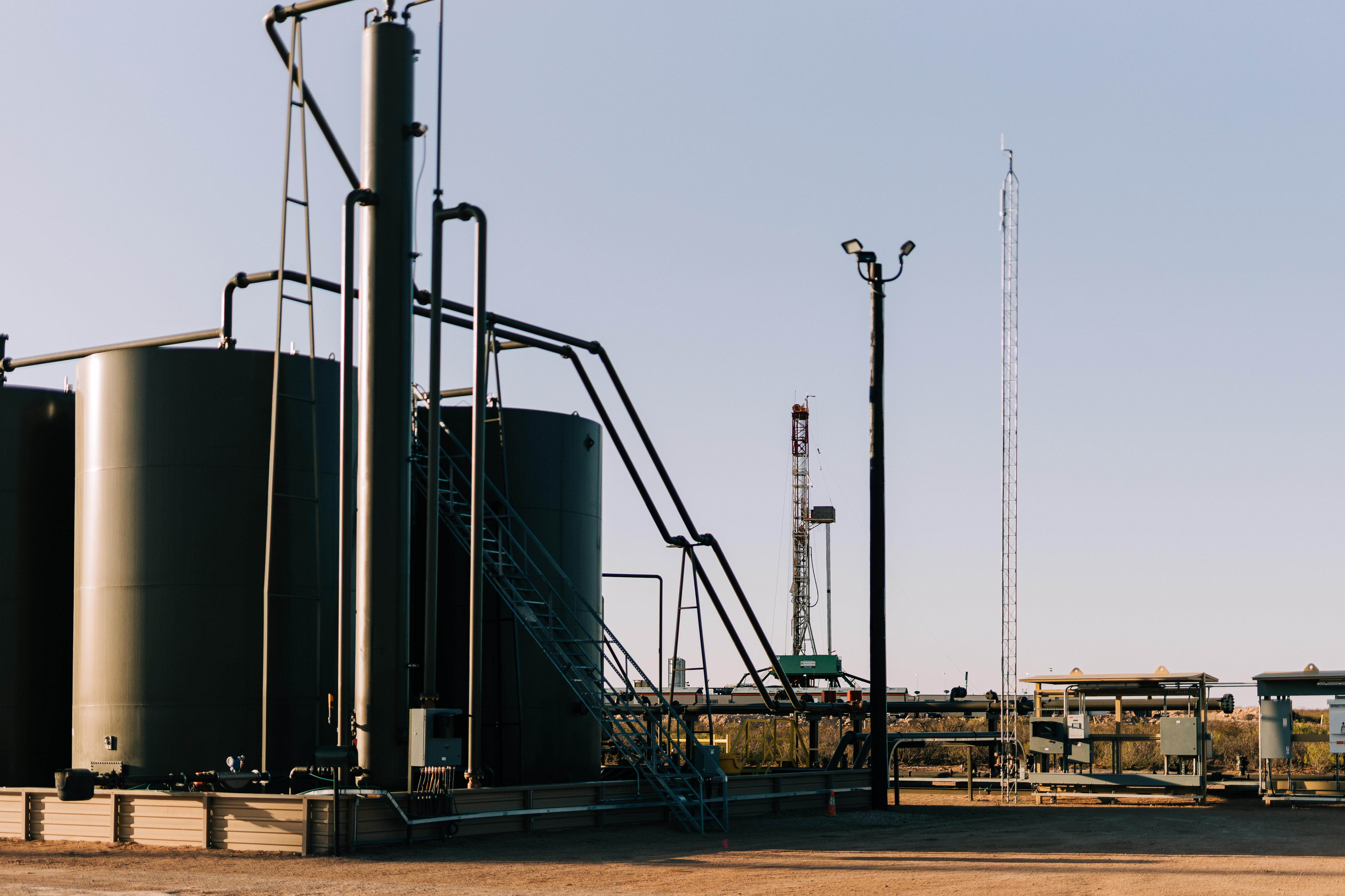 Central tank battery with drilling operations on the next pad