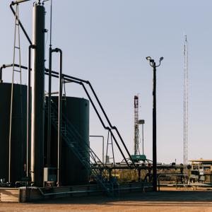 Central tank battery with drilling operations on the next pad